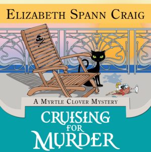 Cover of Cruising for Murder shows a black cat on the deck of a cruise ship next to a deck chair with a skull and crossbones on it. 